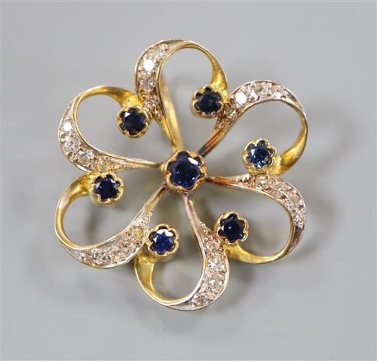 A 750 yellow metal, sapphire and diamond set openwork flower head pendant, 24mm.